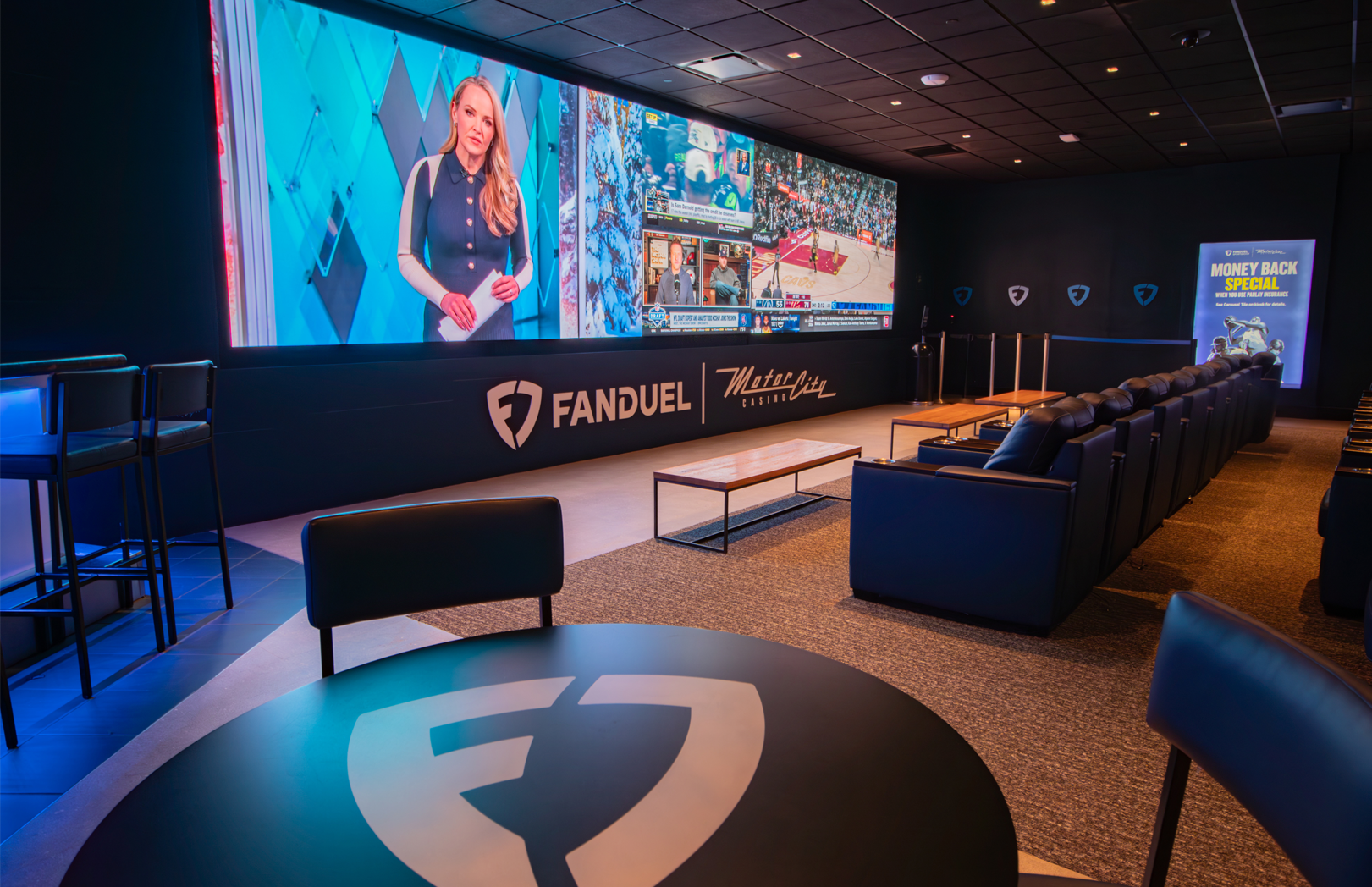 FanDuel sportsbook lounge with bar seating and sports video wall at MotorCity Casino Hotel
