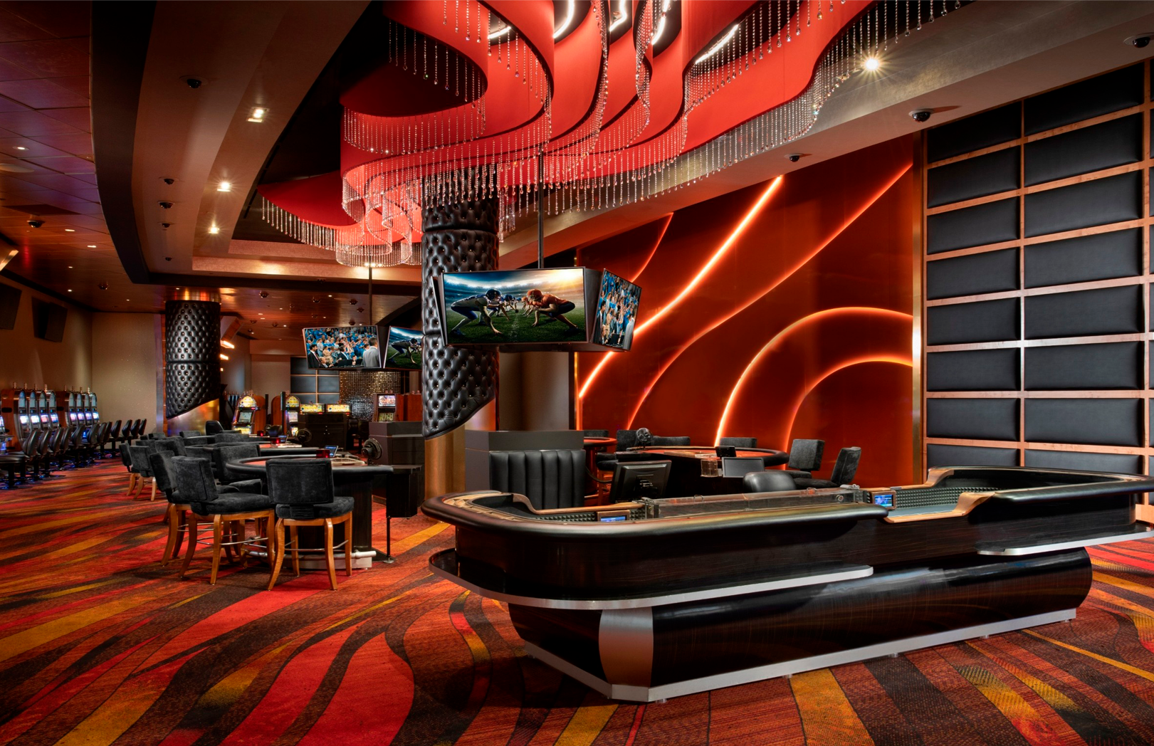 High Limit gaming area with table games and red lighting at MotorCity Casino Hotel