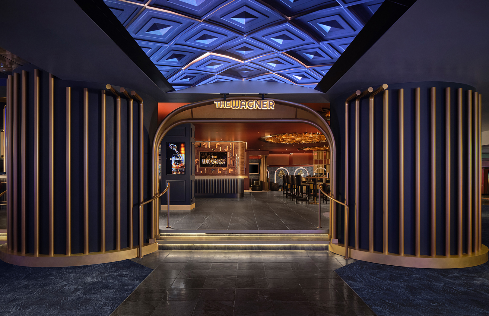 The Wagner entrance at MotorCity Casino Hotel with gold lighting and video ceiling
