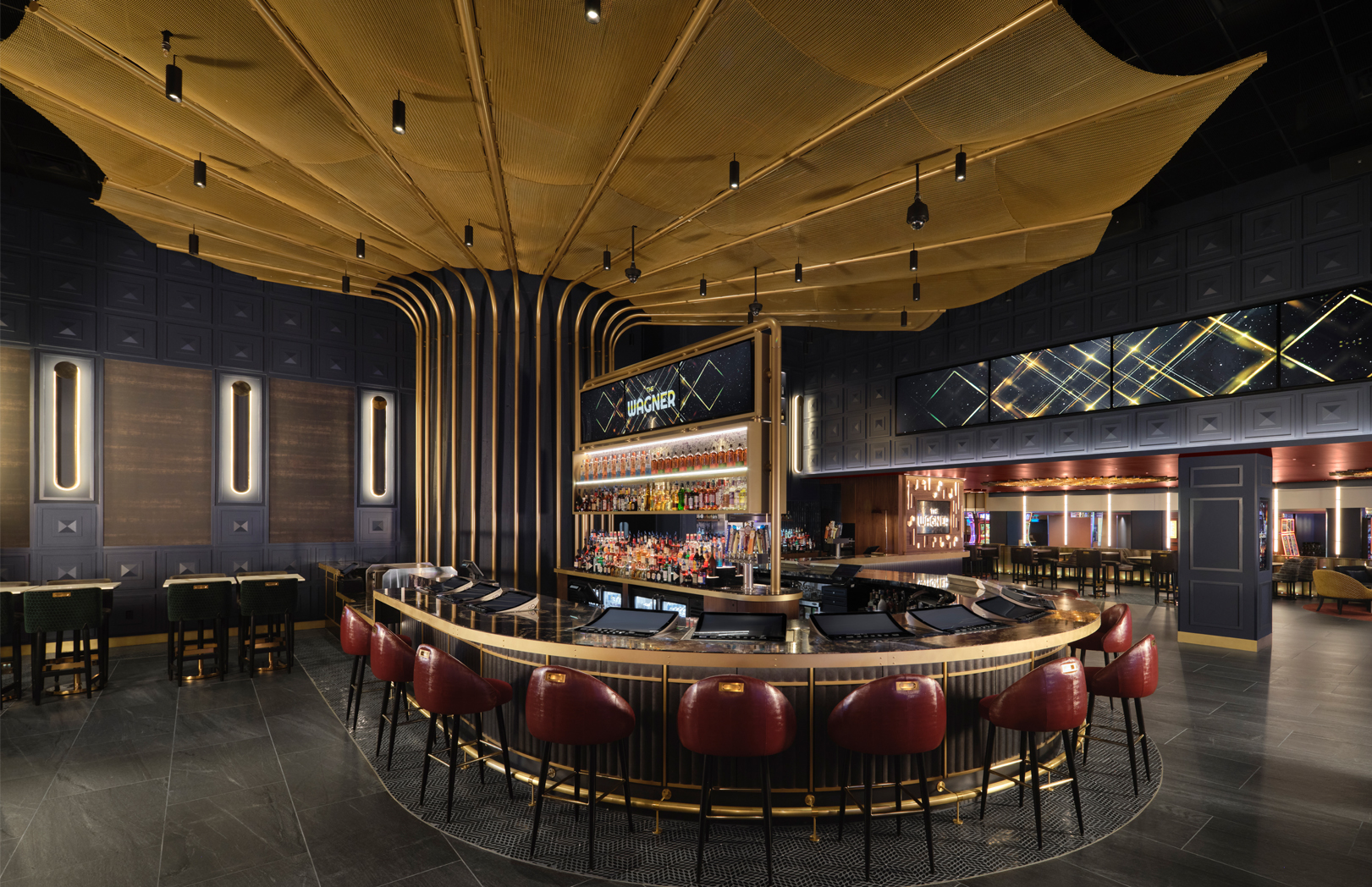 The Wagner bar at MotorCity Casino Hotel with gold-accented smokestack design